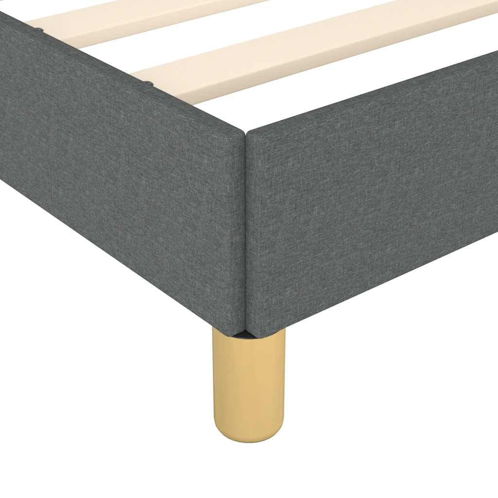 Dark grey upholstered bed frame with wooden slats and gold cylindrical legs