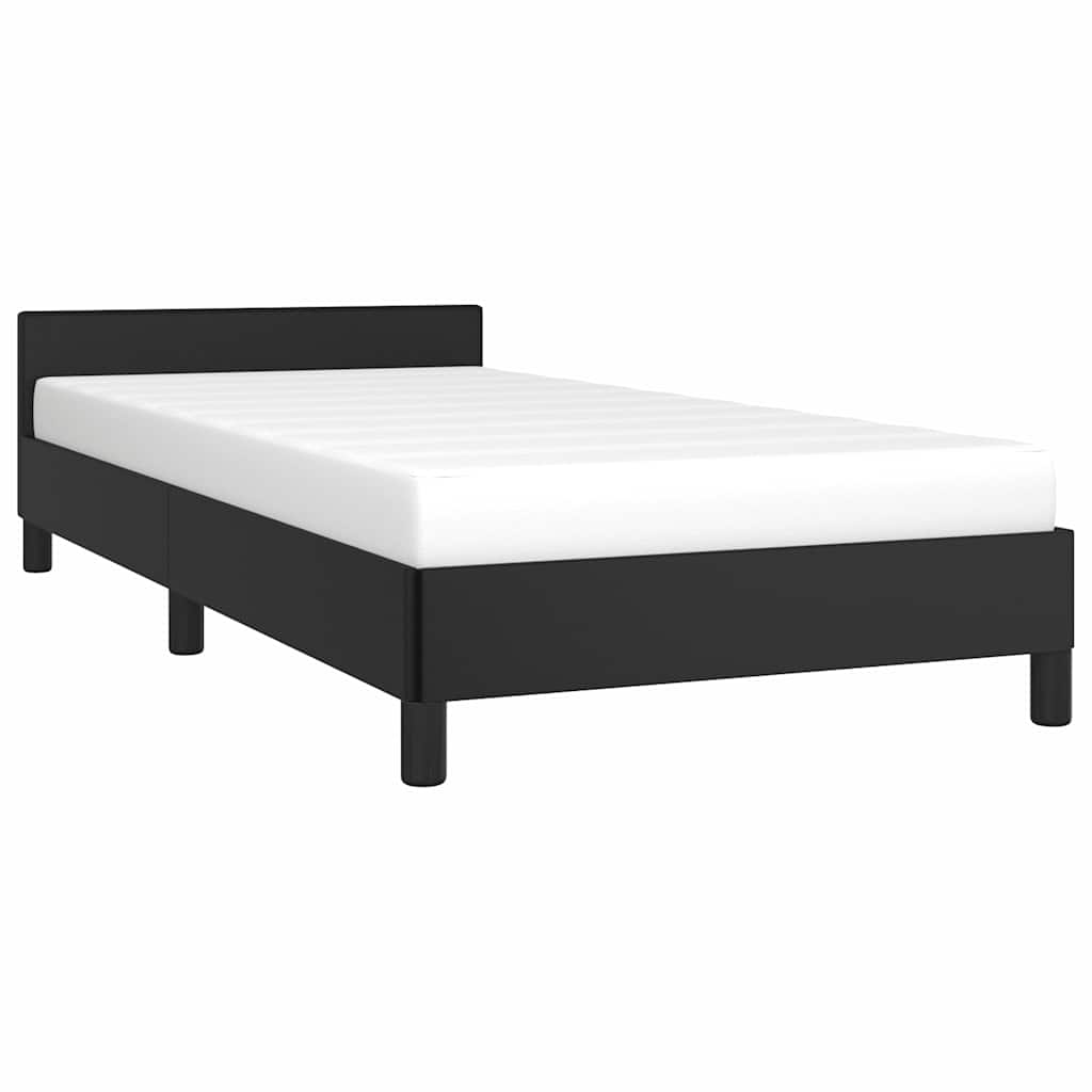 Black upholstered twin bed frame with a white mattress