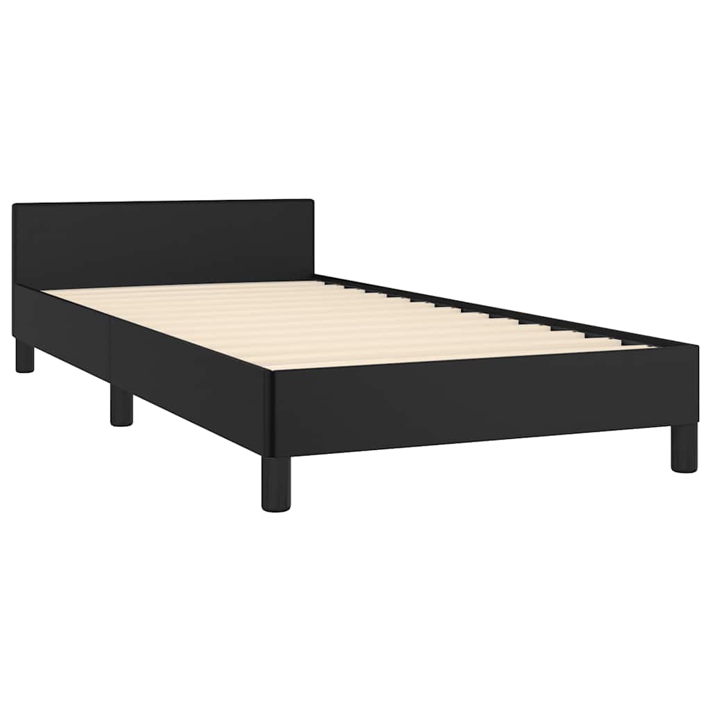 Modern black upholstered twin bed frame with white linens and gray throw blanket
