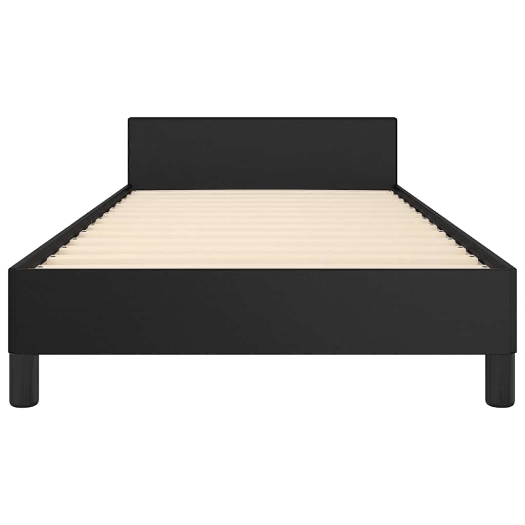 Black upholstered bed frame with white mattress
