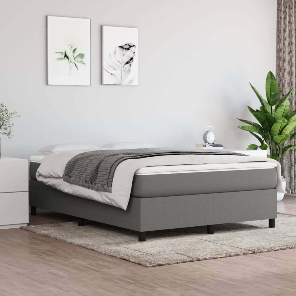 Grey upholstered divan bed with a white mattress and grey throw
