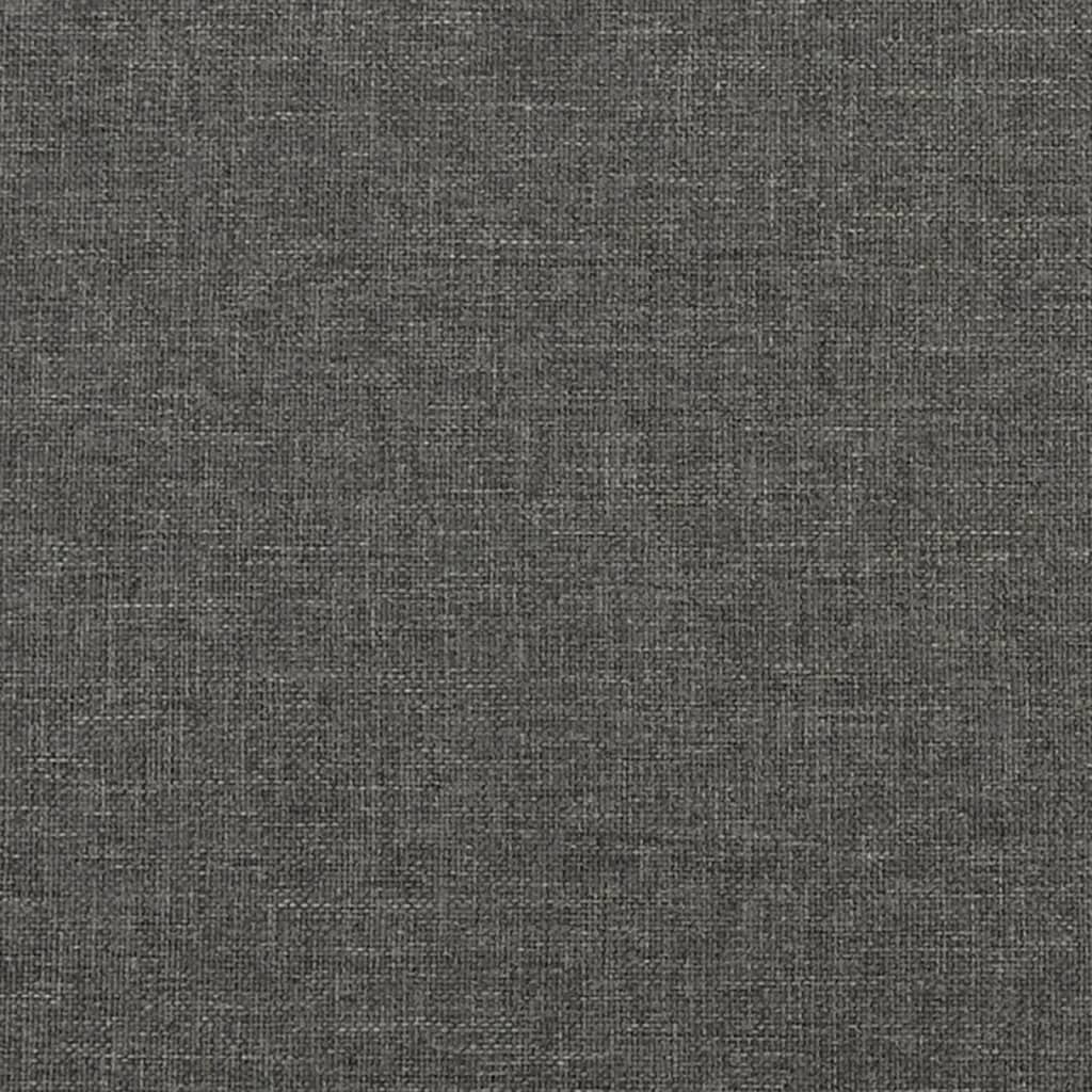 Closeup of a grey upholstered bed frame corner with wooden slats and a black cylindrical leg