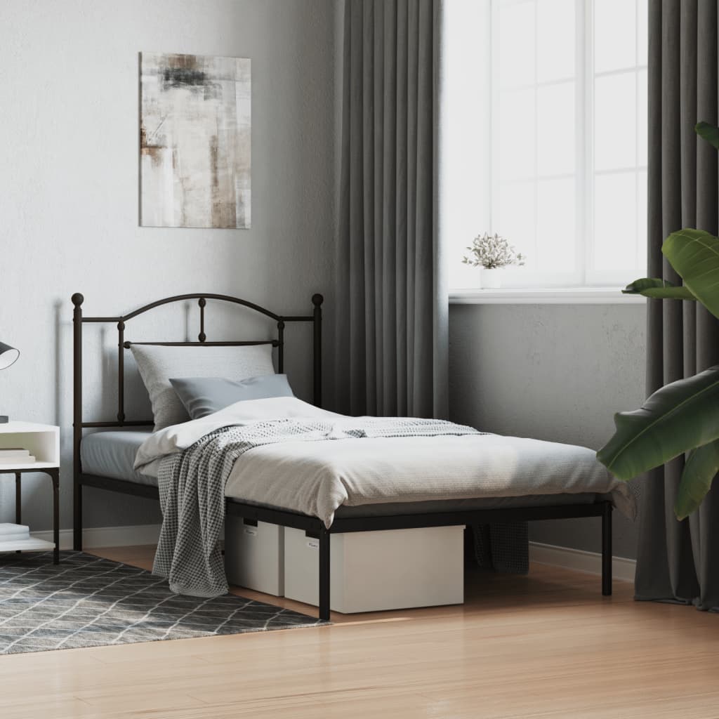 Black metal twin bed frame with ornate headboard and footboard