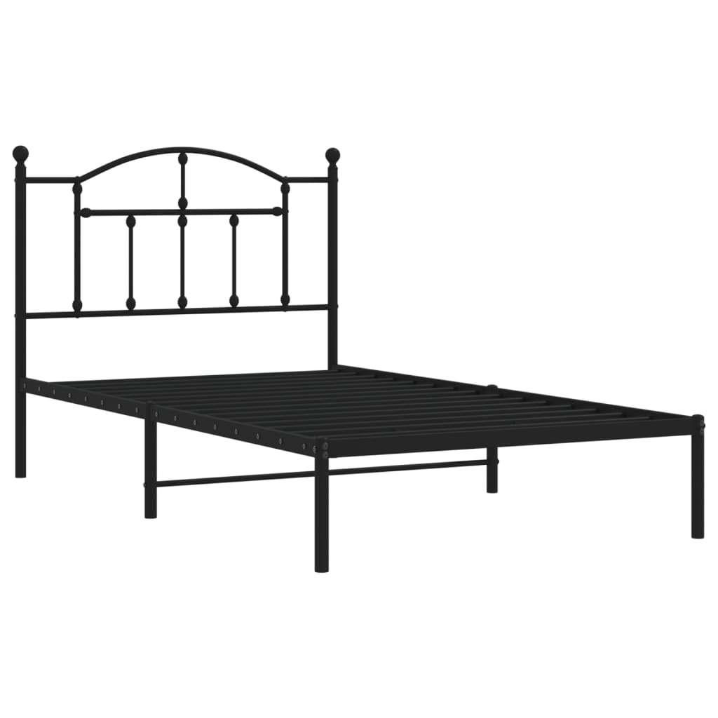 Black metal twin bed frame with a classic arched headboard and mattress