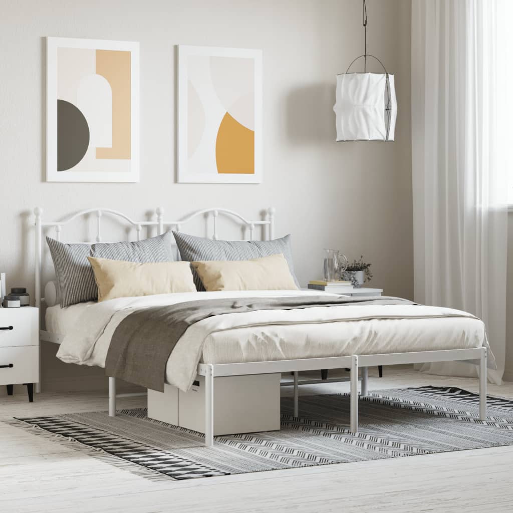 White metal twin bed frame with ornate headboard and footboard featuring upholstered mattress and bedding