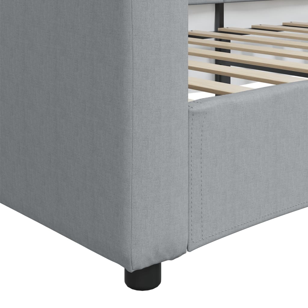 Gray upholstered daybed with curved back viewed from the rear