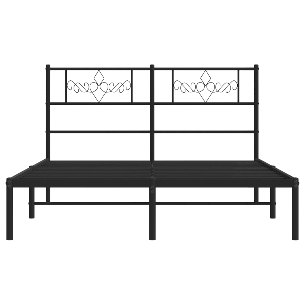 Modern charcoal metal bed frame with ornate headboard detail and patterned bedding
