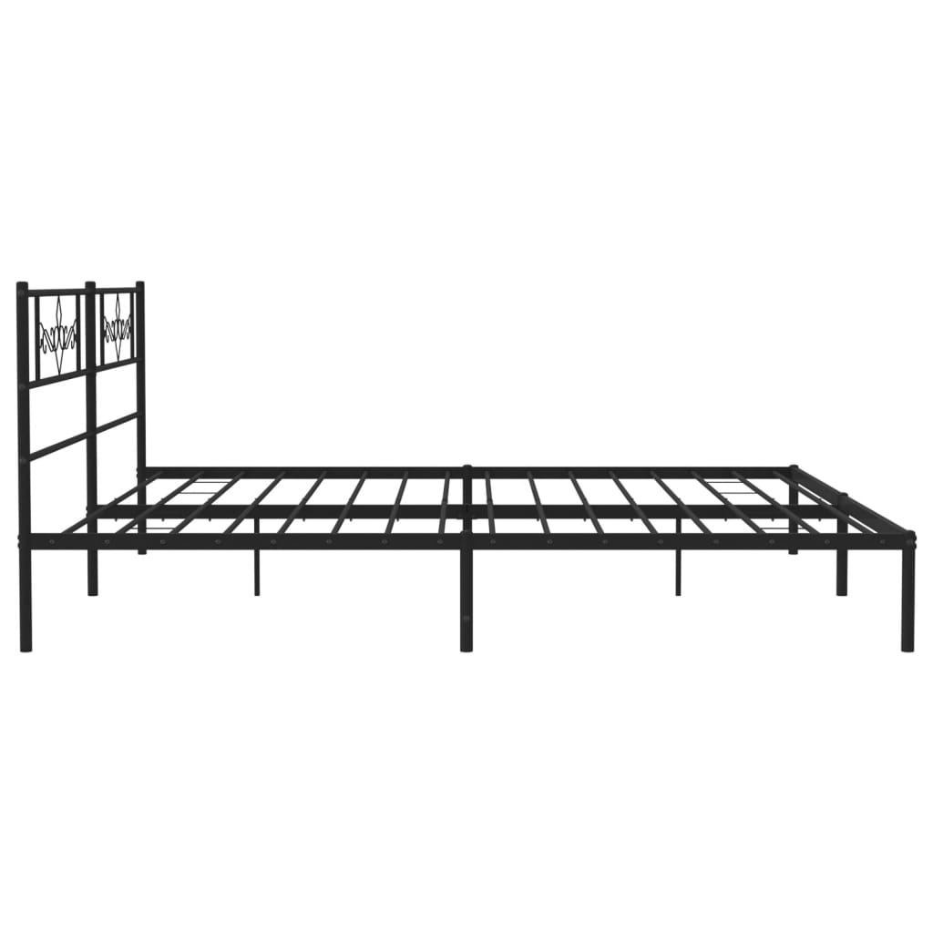 Black metal bed frame with ornate headboard detail and white mattress