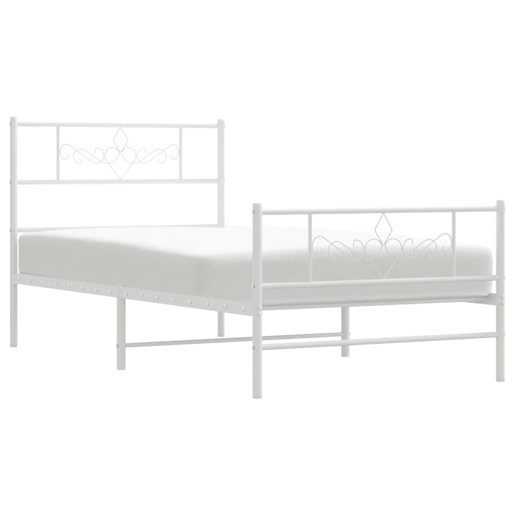 White metal bed frame with decorative scrollwork on headboard and footboard
