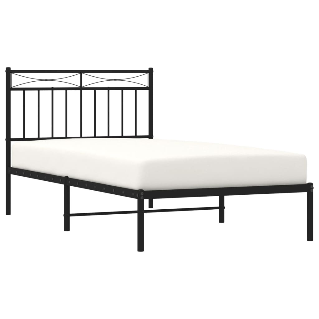Black metal twin bed frame with white mattress and decorative headboard