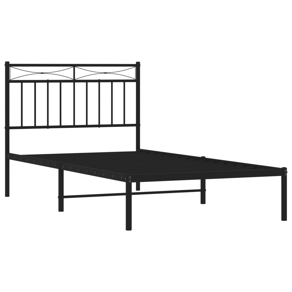 Black metal twin bed frame with decorative headboard and grey patterned bedding