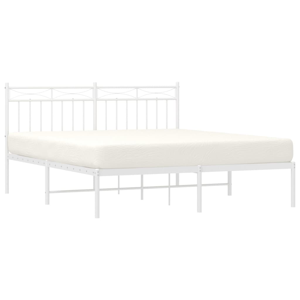 White metal bed frame with a decorative headboard and mattress