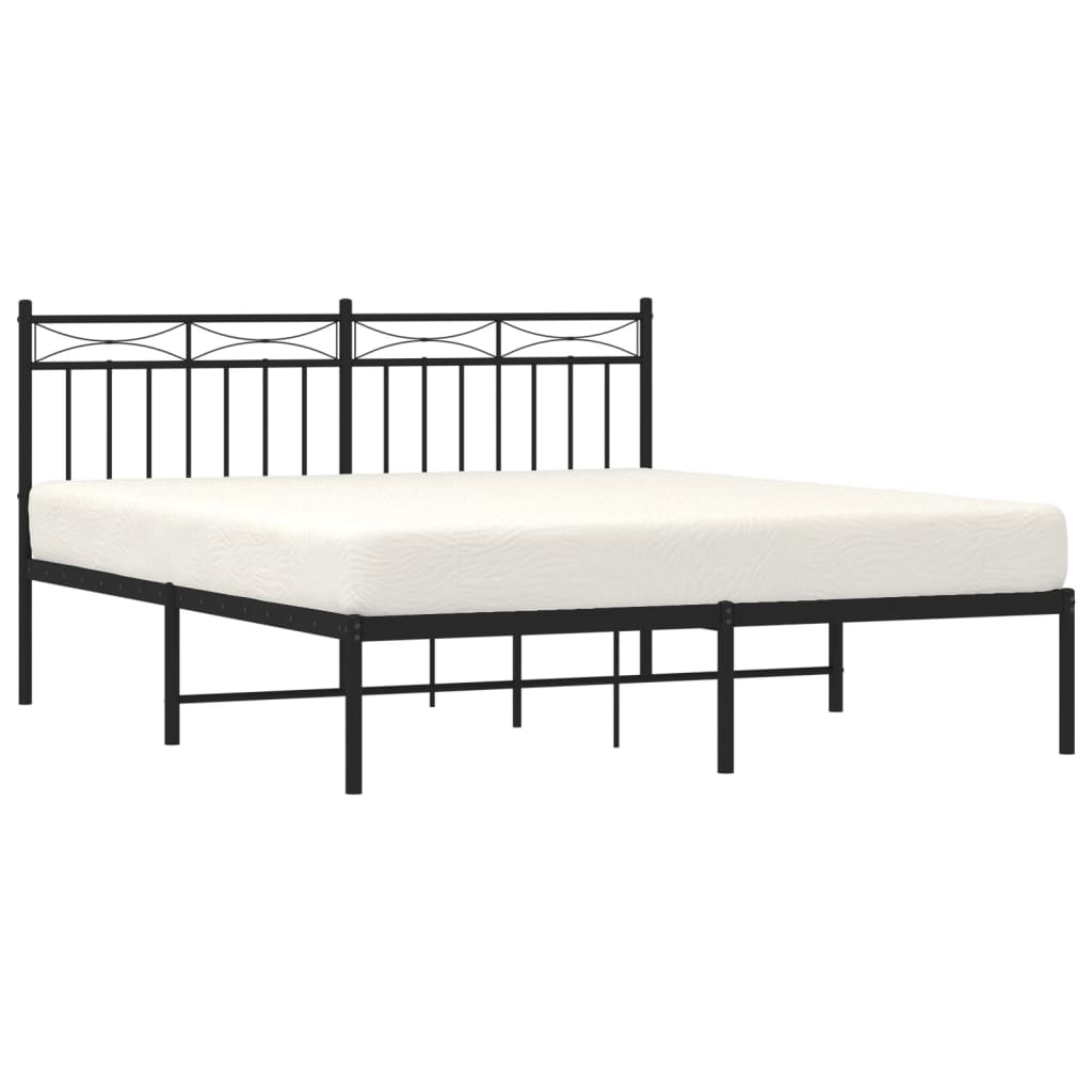 Black metal bed frame with ornate headboard and white mattress