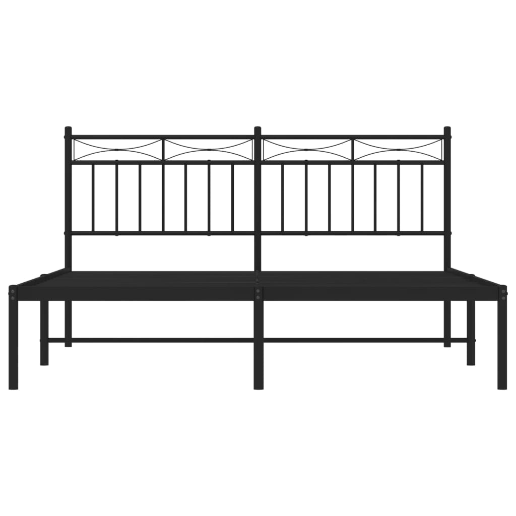 Black metal platform bed frame with a white mattress and decorative headboard