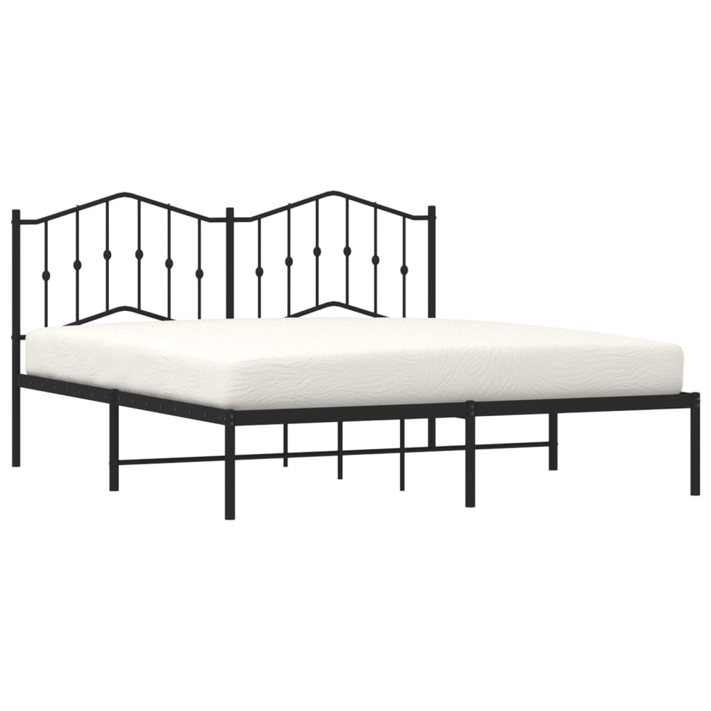 Black metal bed frame with ornate headboard and white mattress
