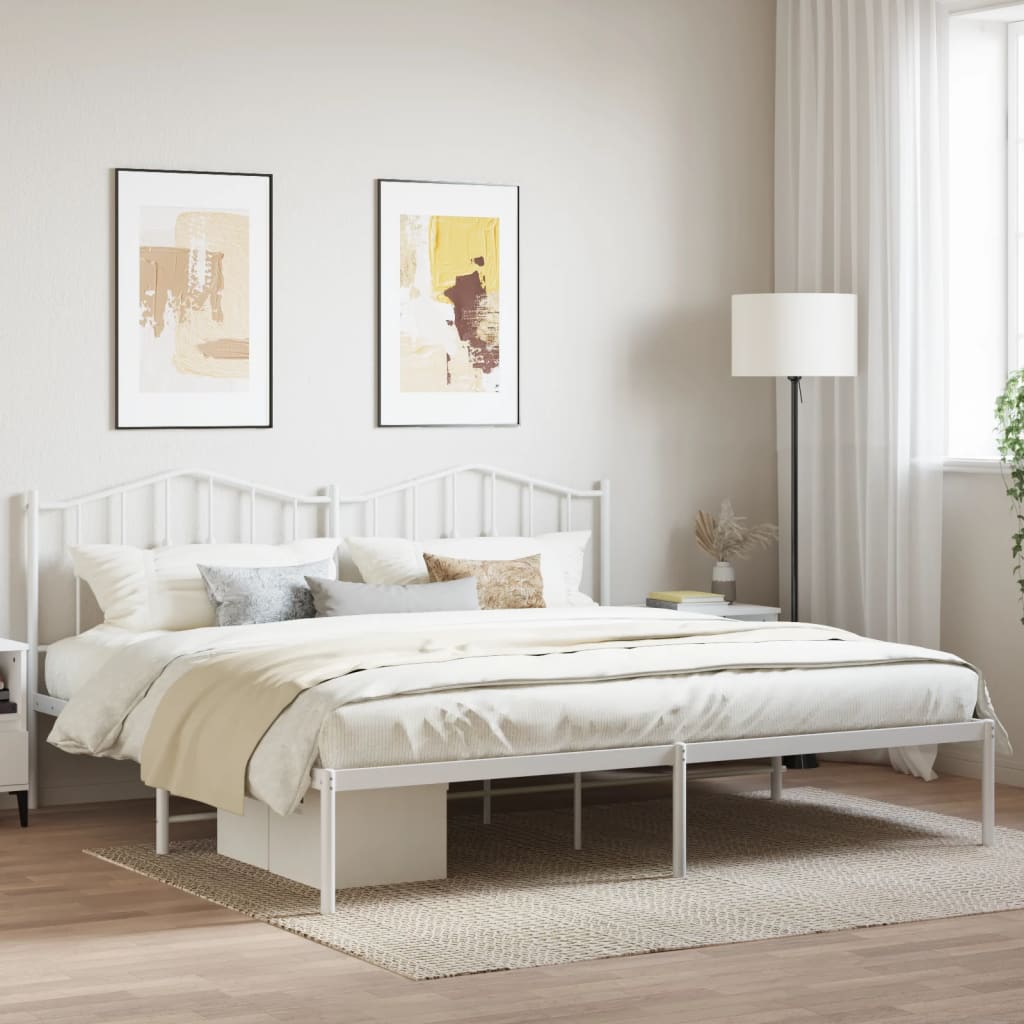 White metal bed frame with ornate headboard and footboard