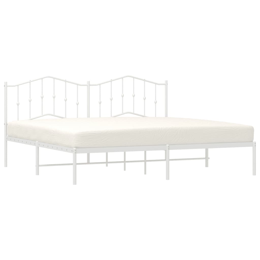 White metal bed frame with decorative heartshaped finials on the headboard