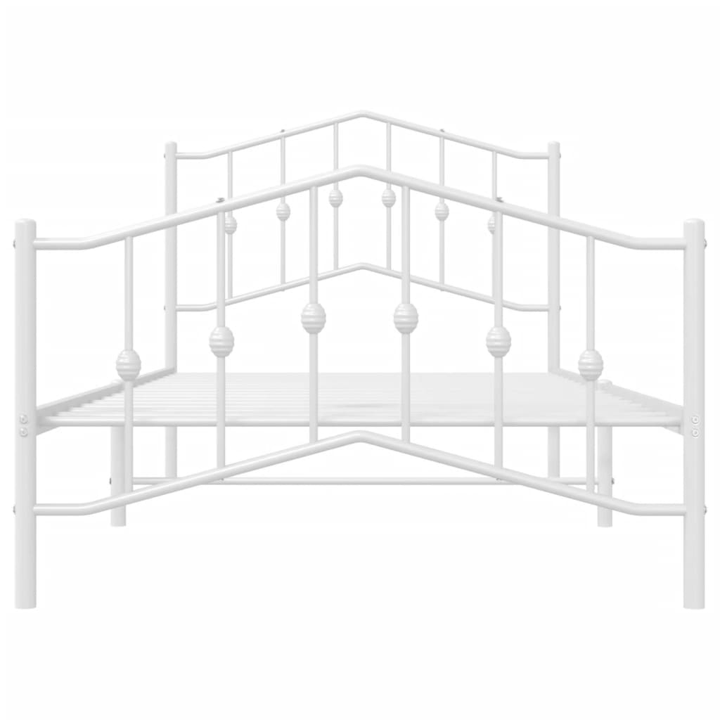 White metal bed frame with ornate headboard and footboard including a mattress