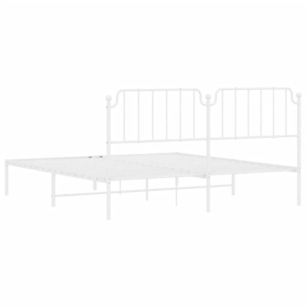 White metal twin bed frame with decorative headboard and slatted base