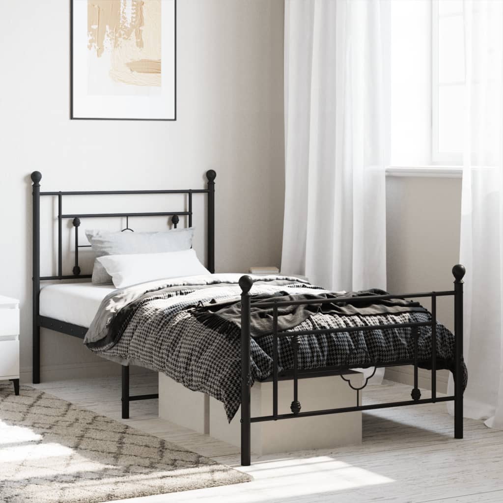 Black metal twin bed frame with decorative scrollwork on headboard and footboard
