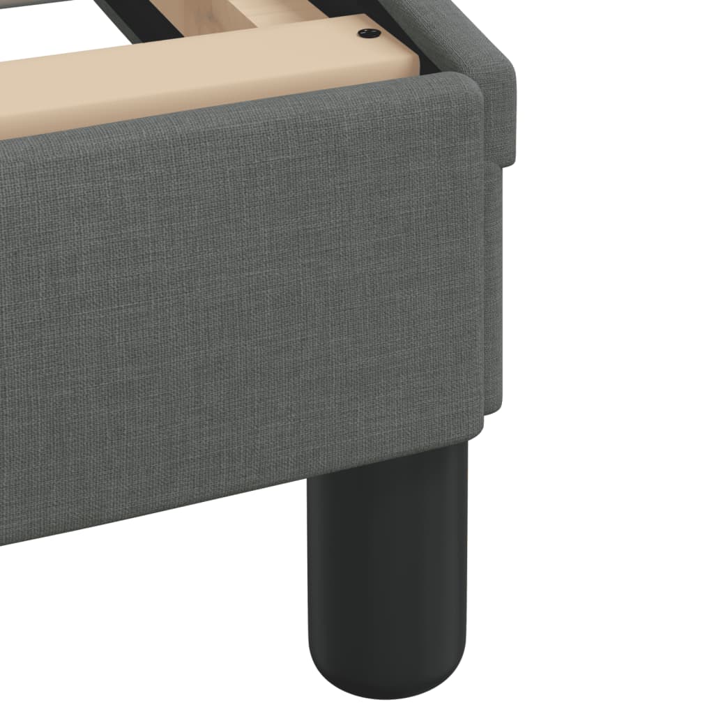 Gray upholstered bed frame with wooden slats and a dark gray headboard