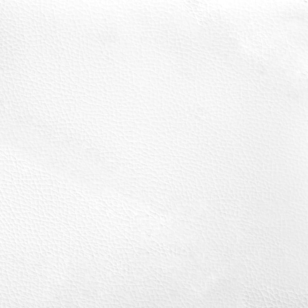 Closeup of a tufted white faux leather headboard with a rounded corner