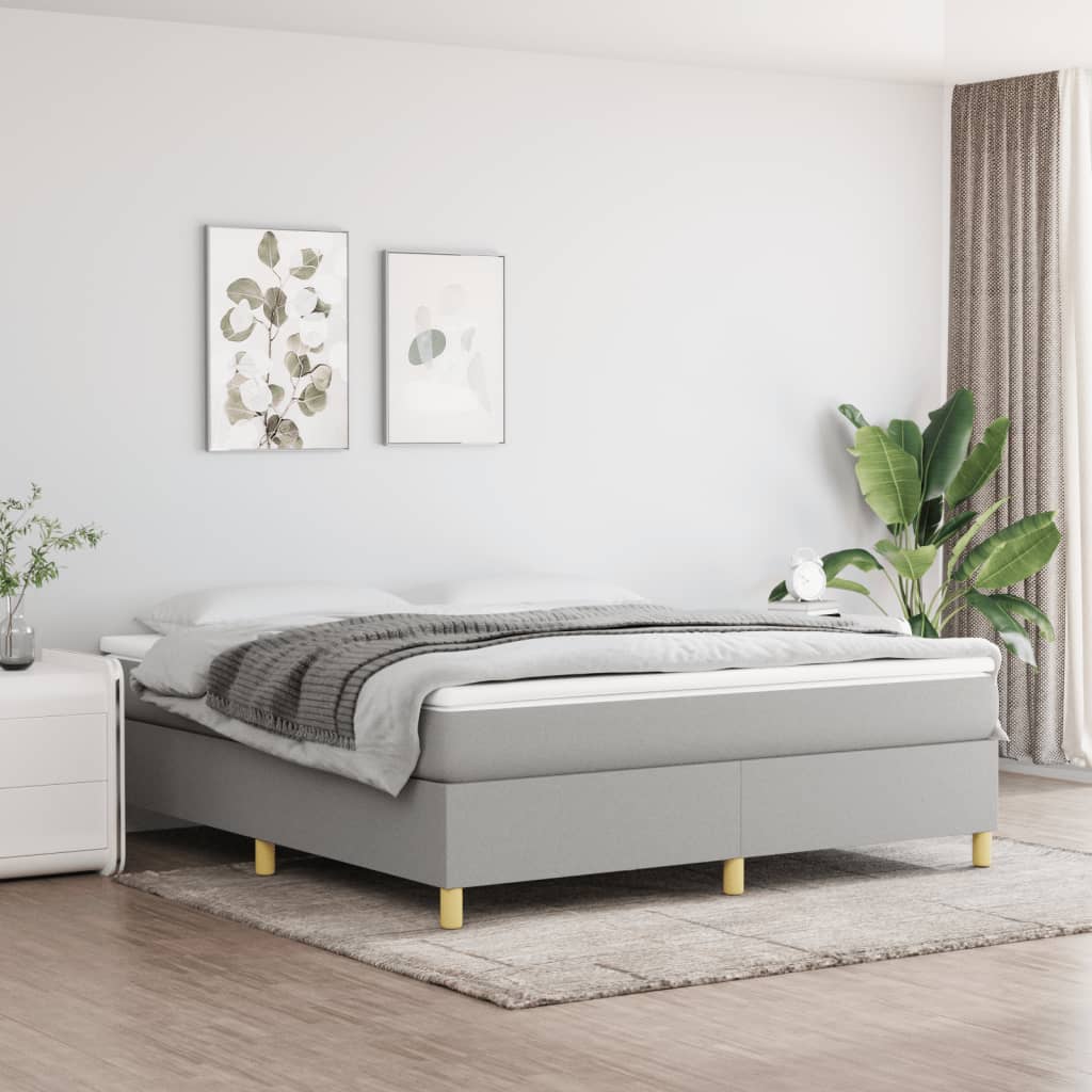 Grey upholstered divan bed with wooden legs