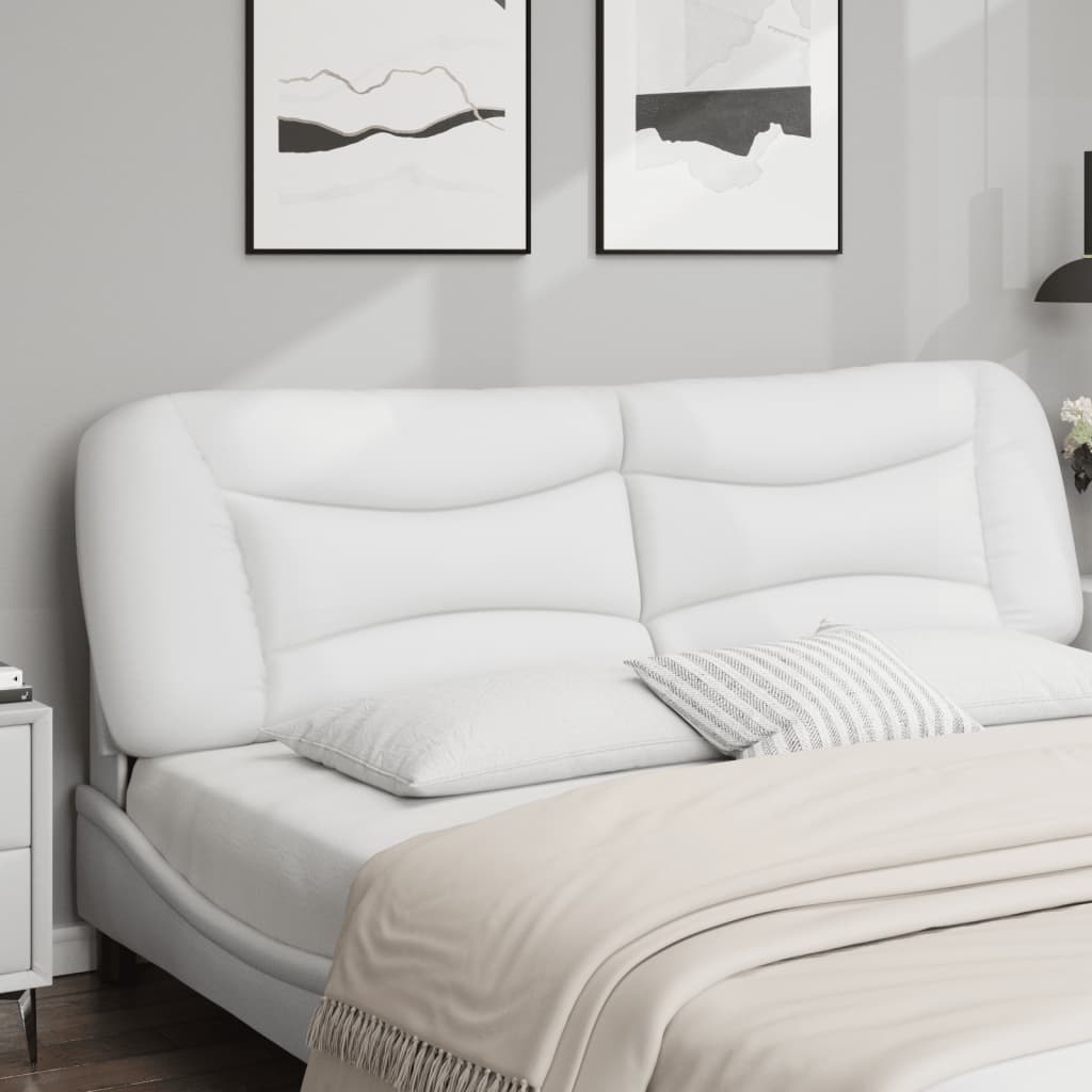 White upholstered tufted headboard attached to a wall above a bed