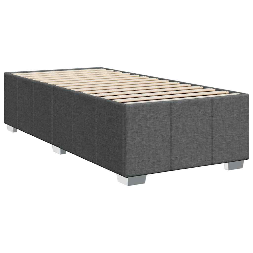 Dark gray upholstered divan bed frame with white mattress and duvet