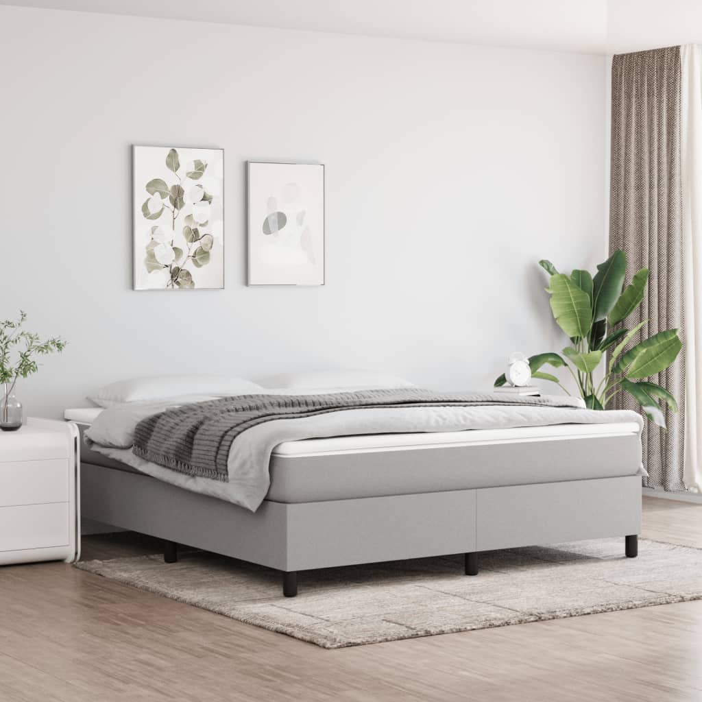 Modern grey upholstered divan bed with mattress and duvet