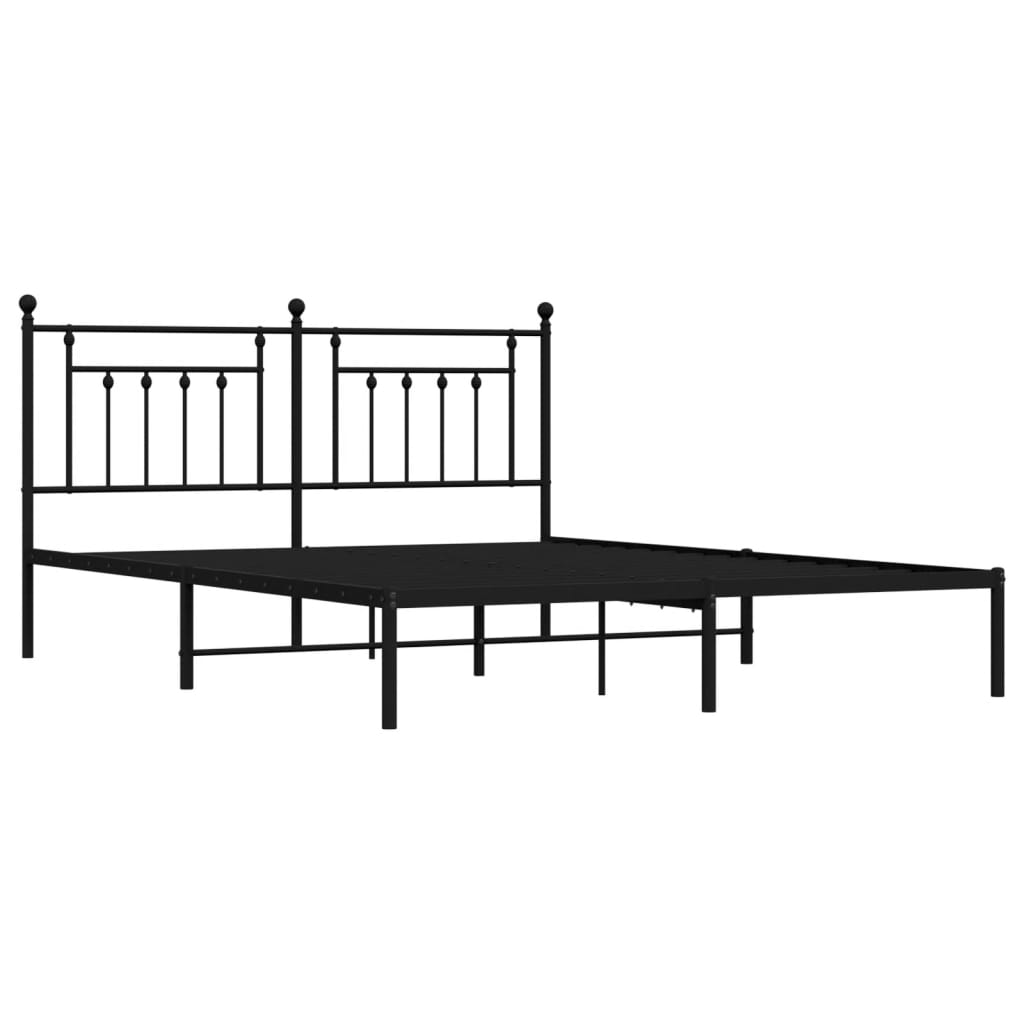 Black metal bed frame with ornate headboard and white mattress
