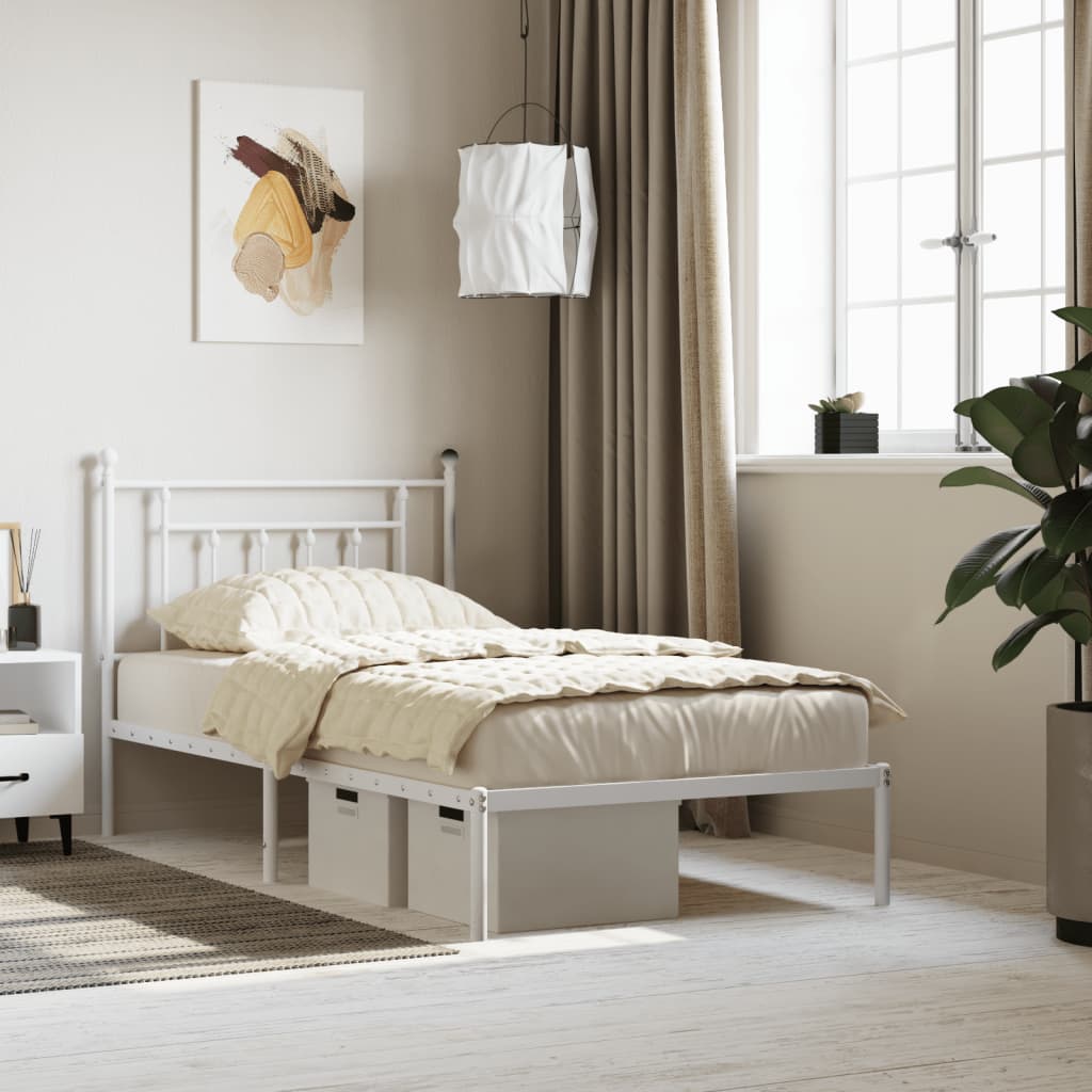 White metal twin bed frame with decorative headboard and footboard