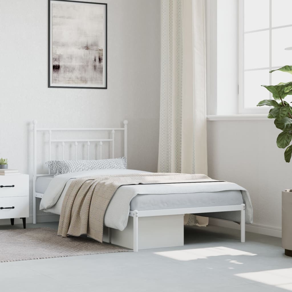 White metal single bed frame with a slatted base and decorative headboard