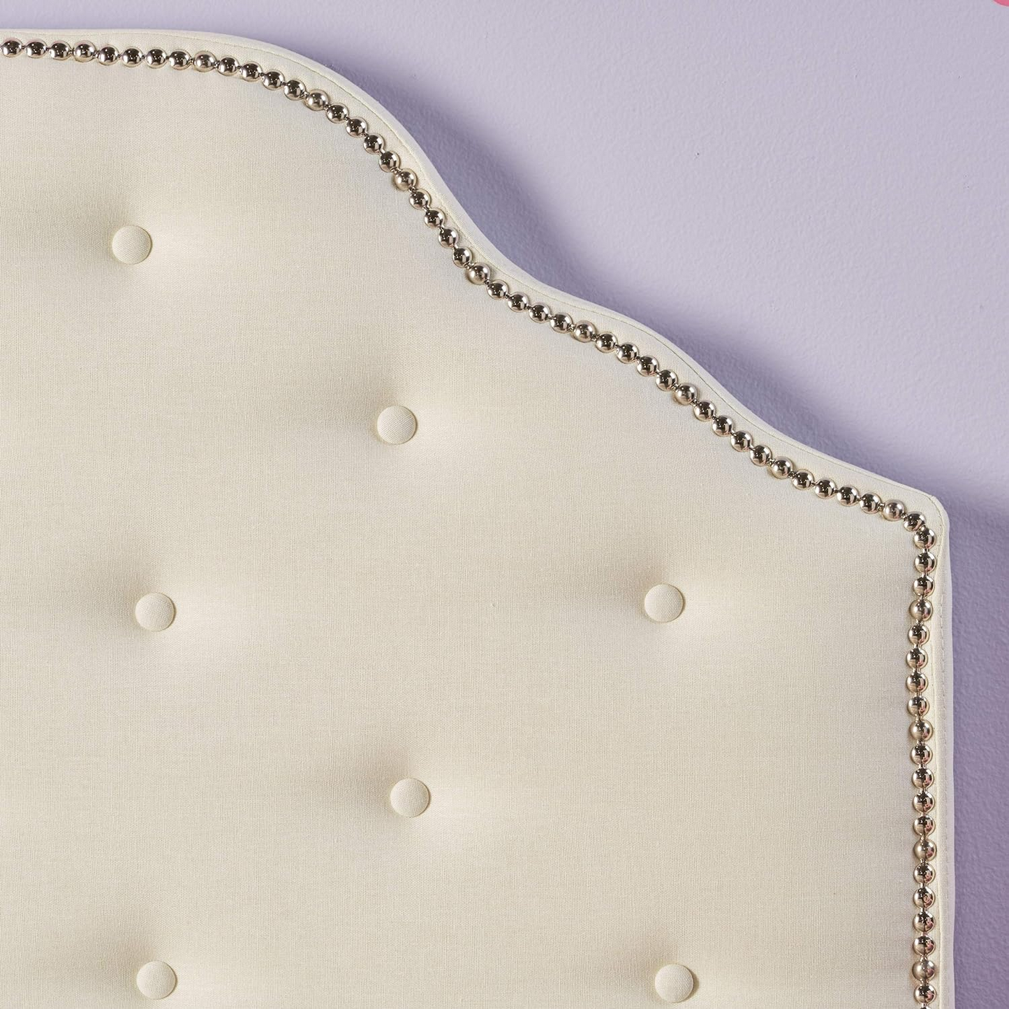 Cream fabric tufted headboard with silver nailhead trim