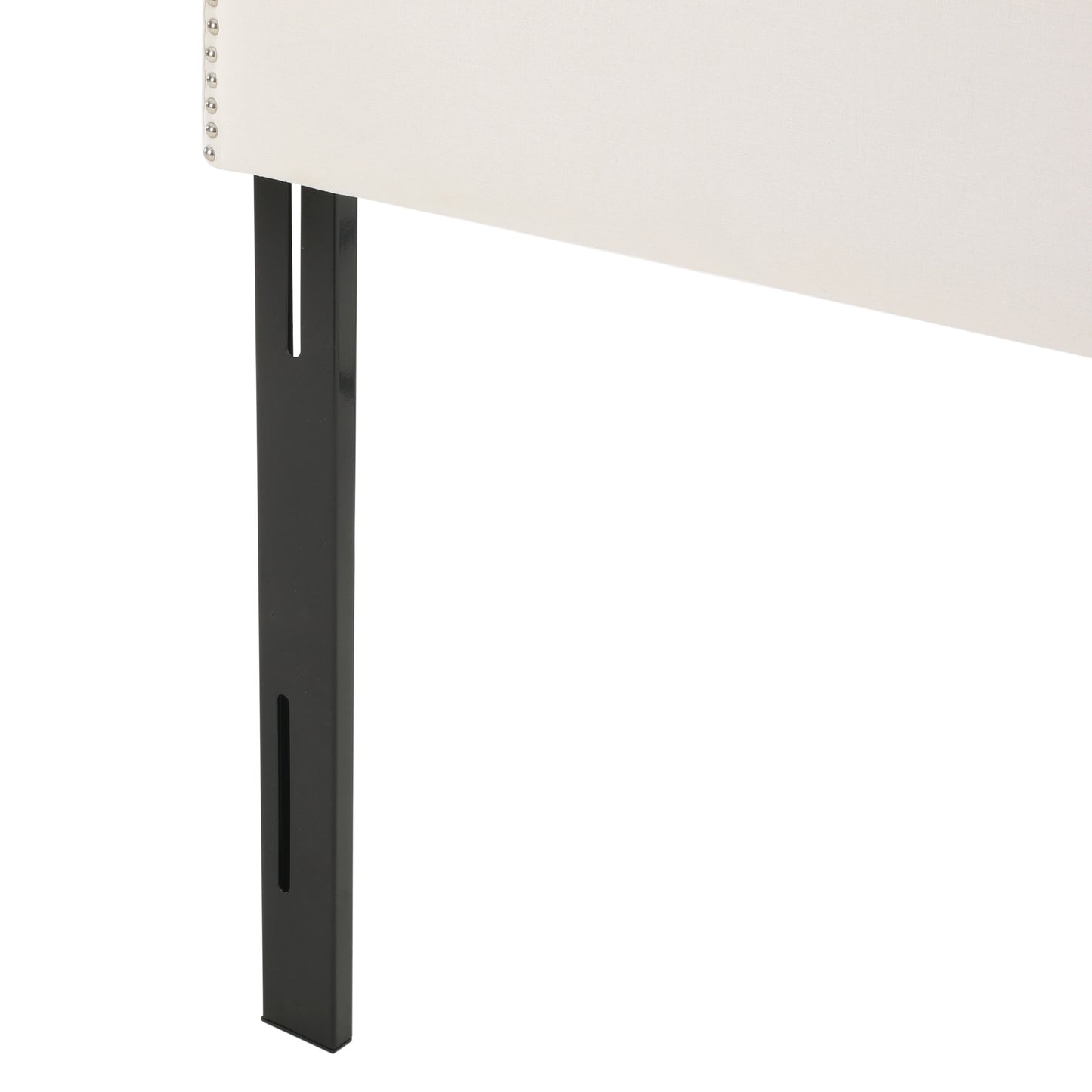 Upholstered headboard detail with nailhead trim and black metal legs