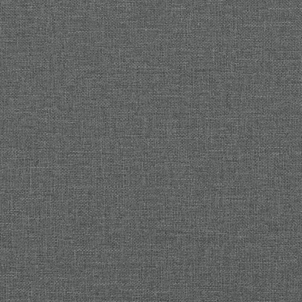 Closeup of a grey upholstered bed frame with silver nailhead trim