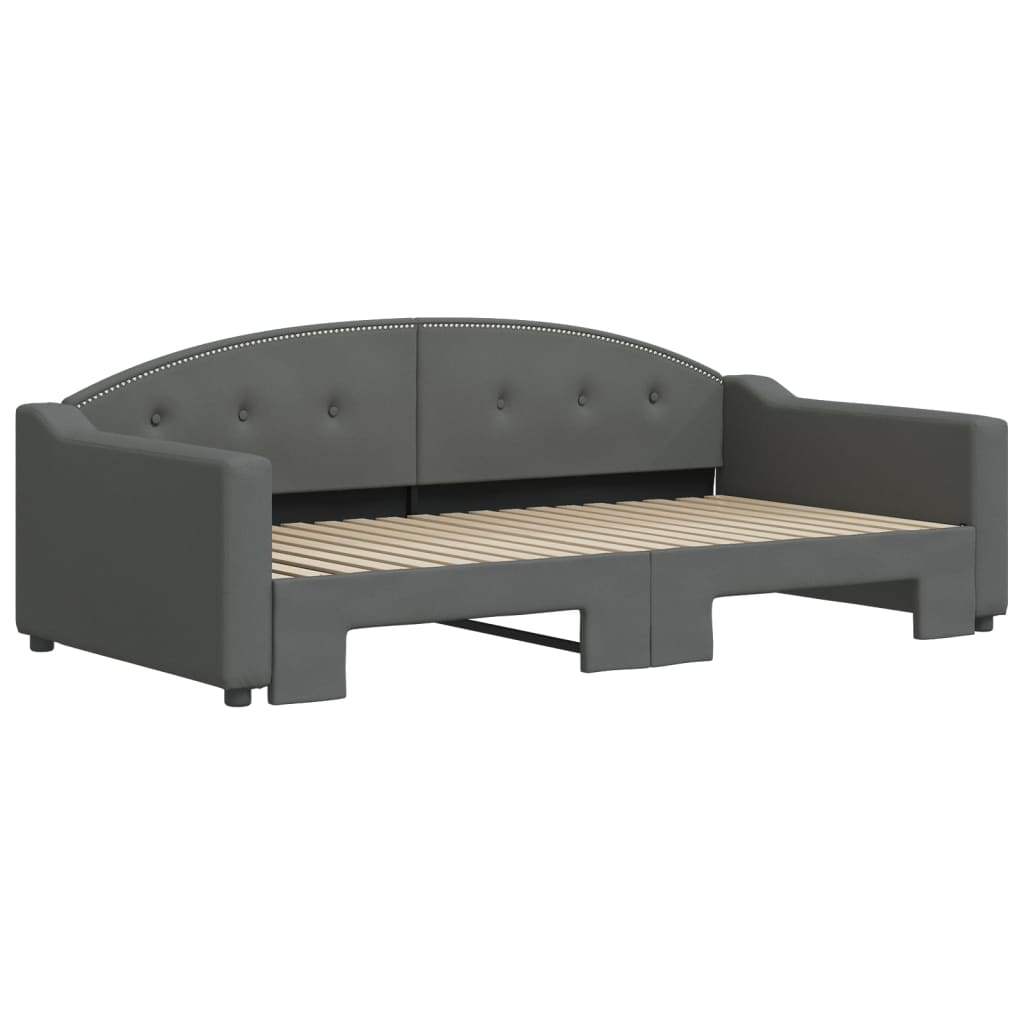Dark gray upholstered twin daybed with pullout trundle tufted back and silver nailhead trim