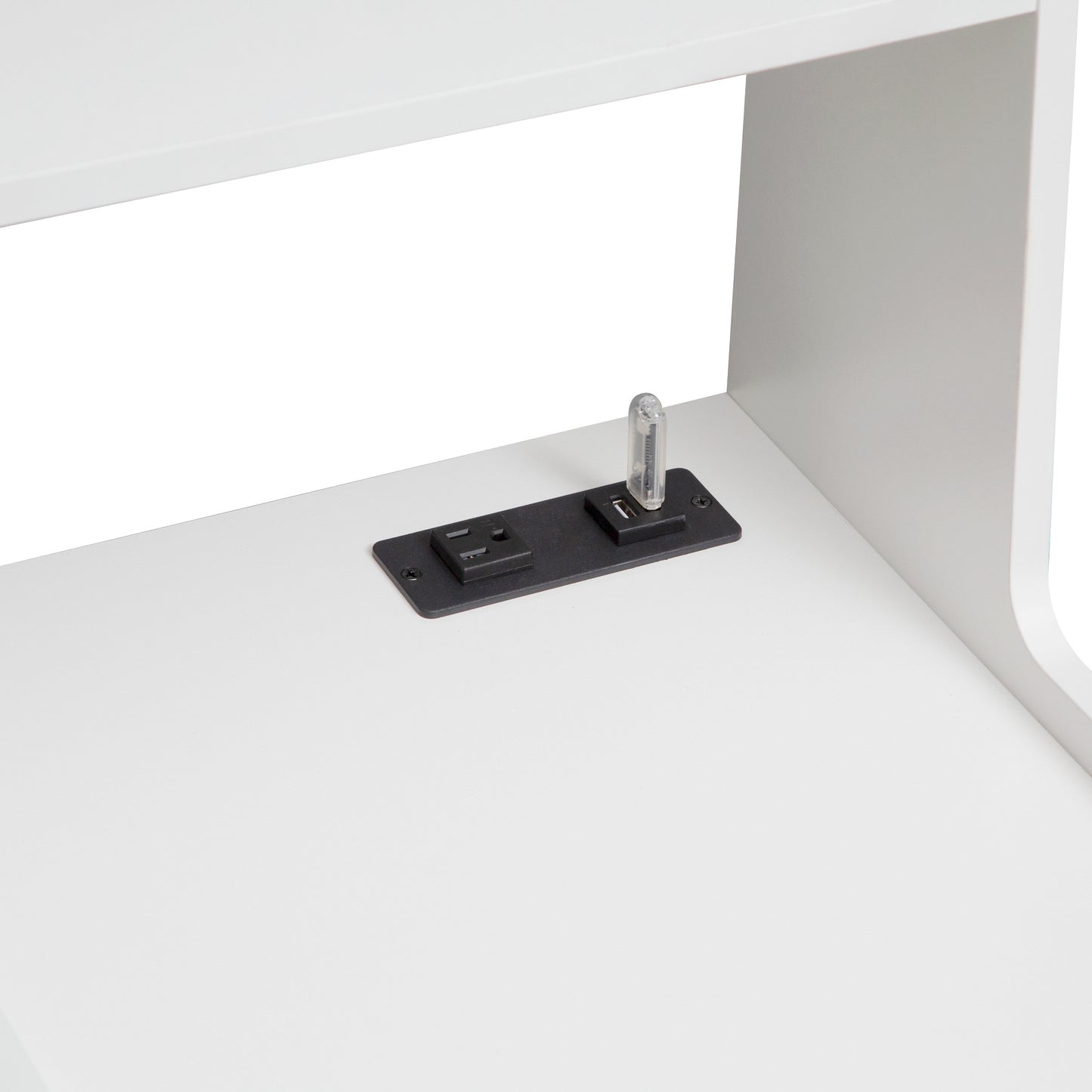 Integrated power strip with USB ports on a white desk surface
