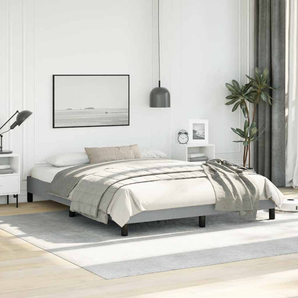 Gray fabric upholstered platform bed frame with wooden slats and black legs