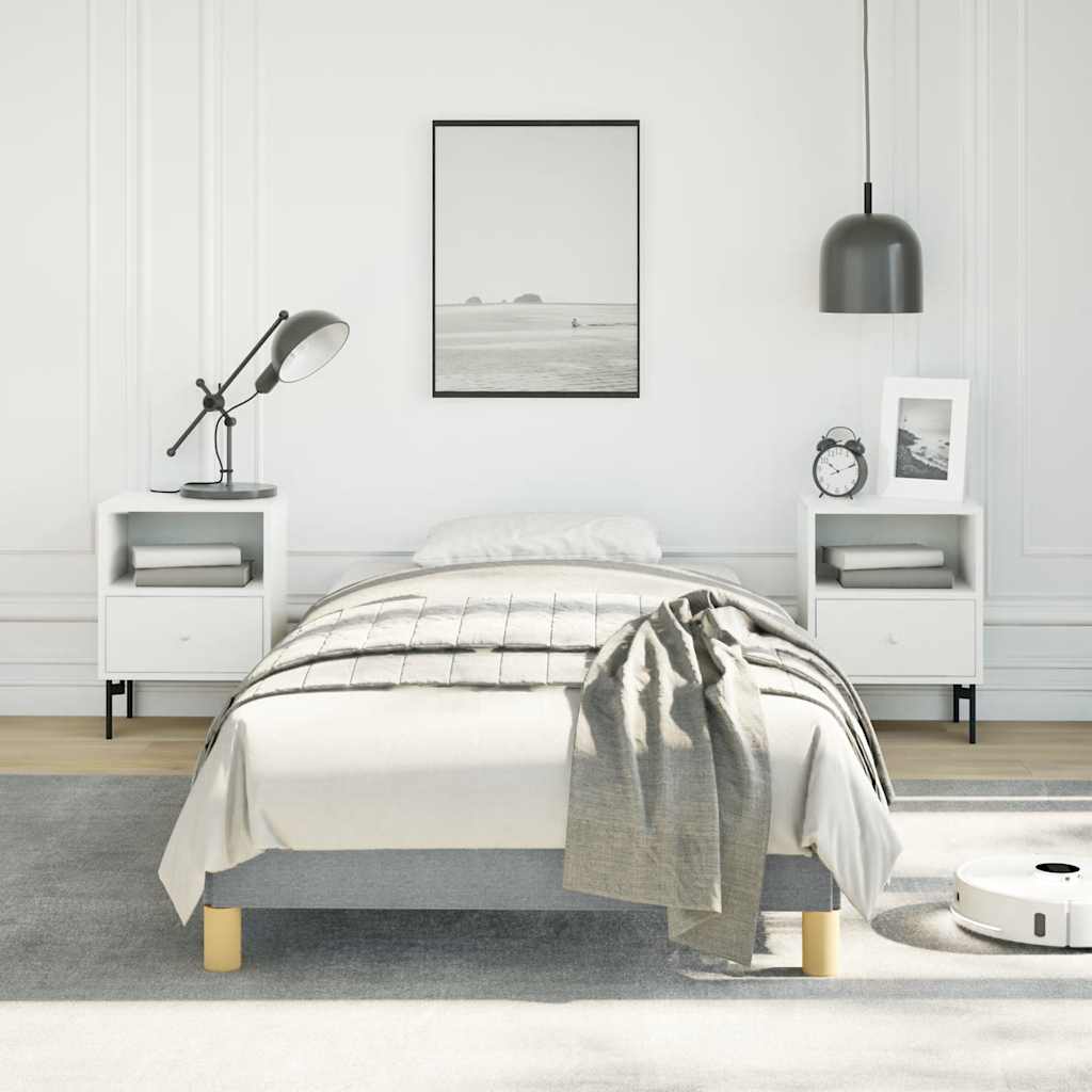 Modern twin bed frame with grey upholstered base and gold legs