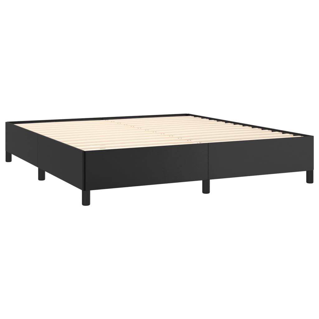 Dark grey upholstered queen size bed frame with a white quilted comforter and grey throw blanket
