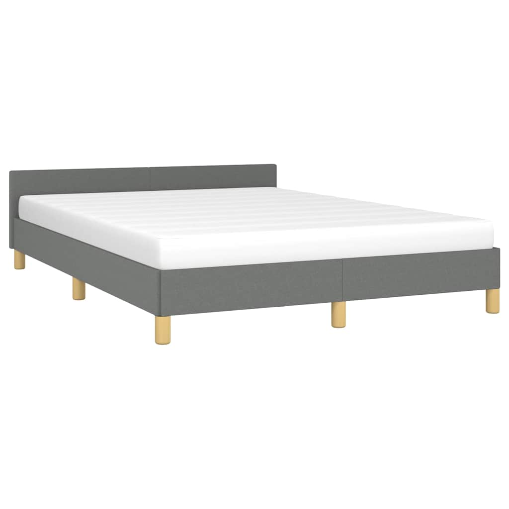 Grey upholstered bed frame with a white mattress and light wood legs
