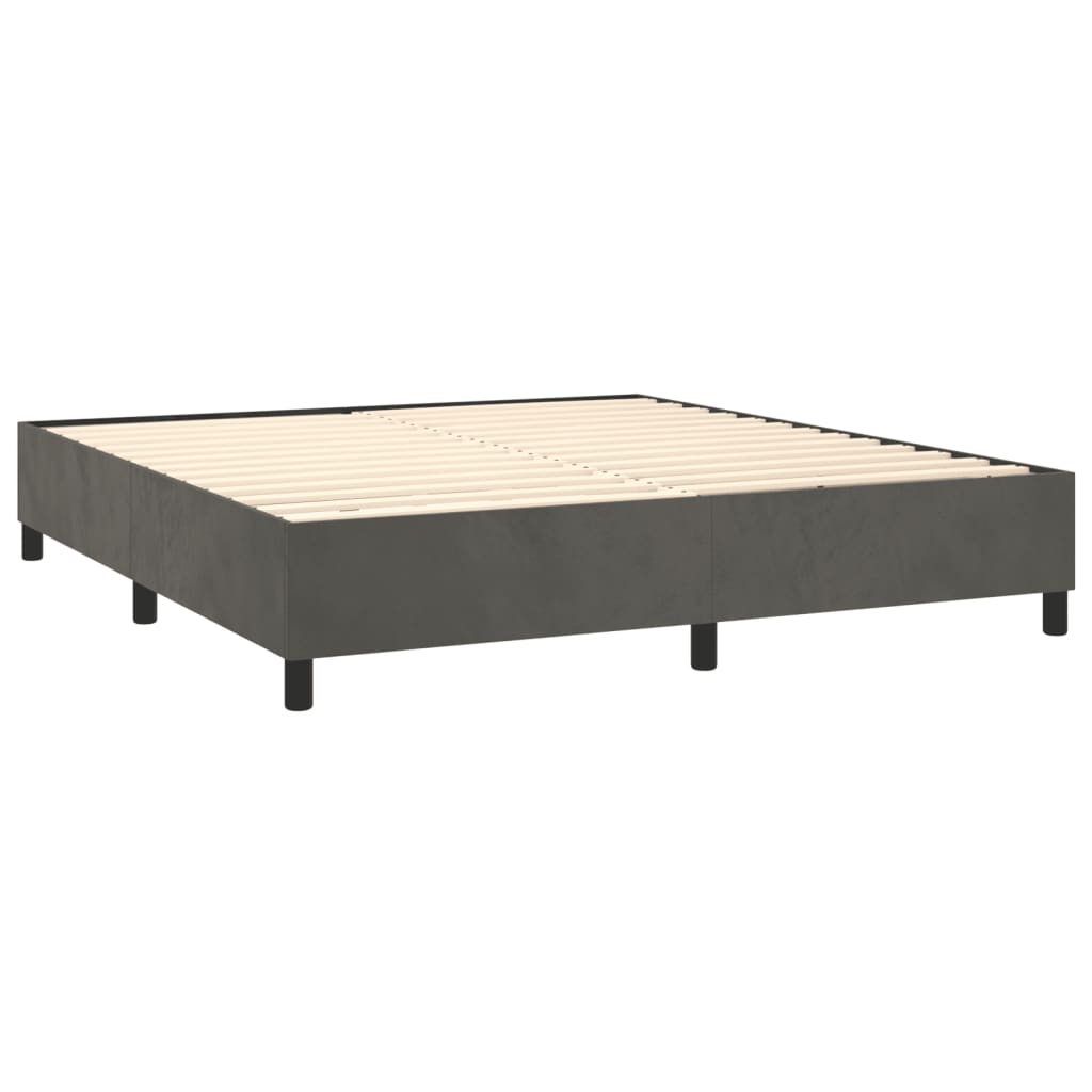 Dark grey upholstered divan bed base with white mattress
