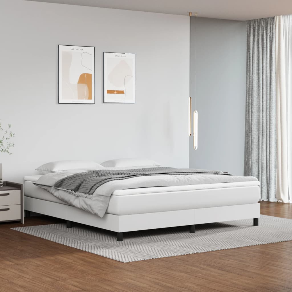White upholstered platform bed with grey throw blanket