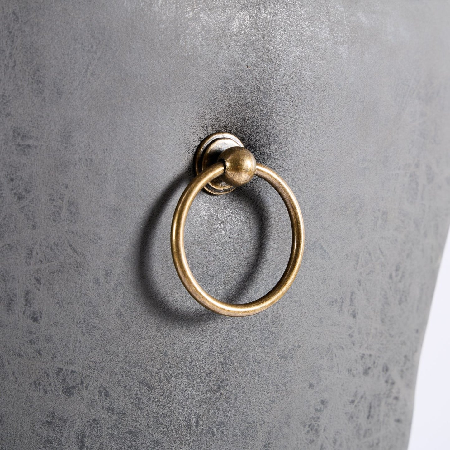 Grey faux leather dining chair with brass ring pull detail