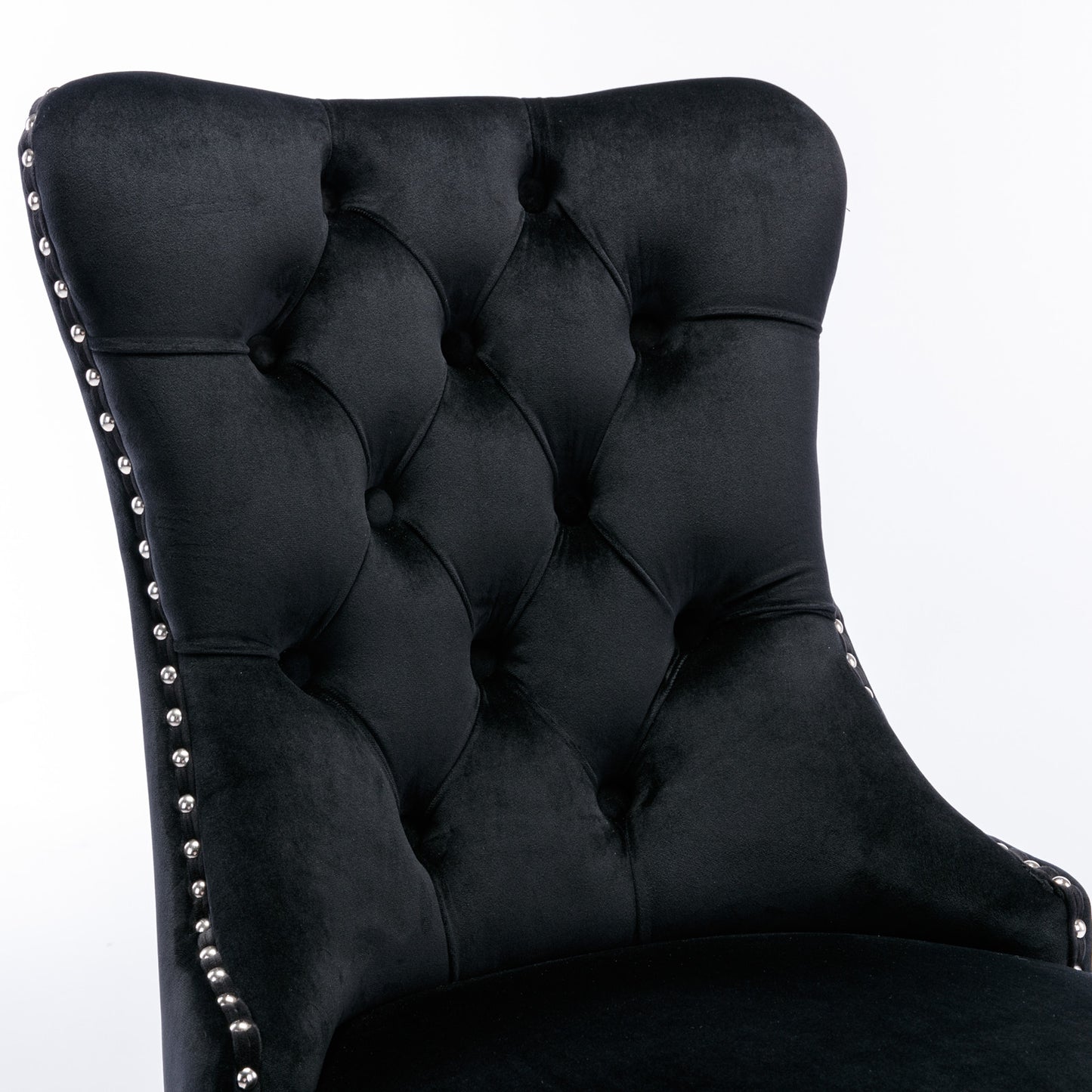 Black velvet tufted accent chair with silver nailhead trim