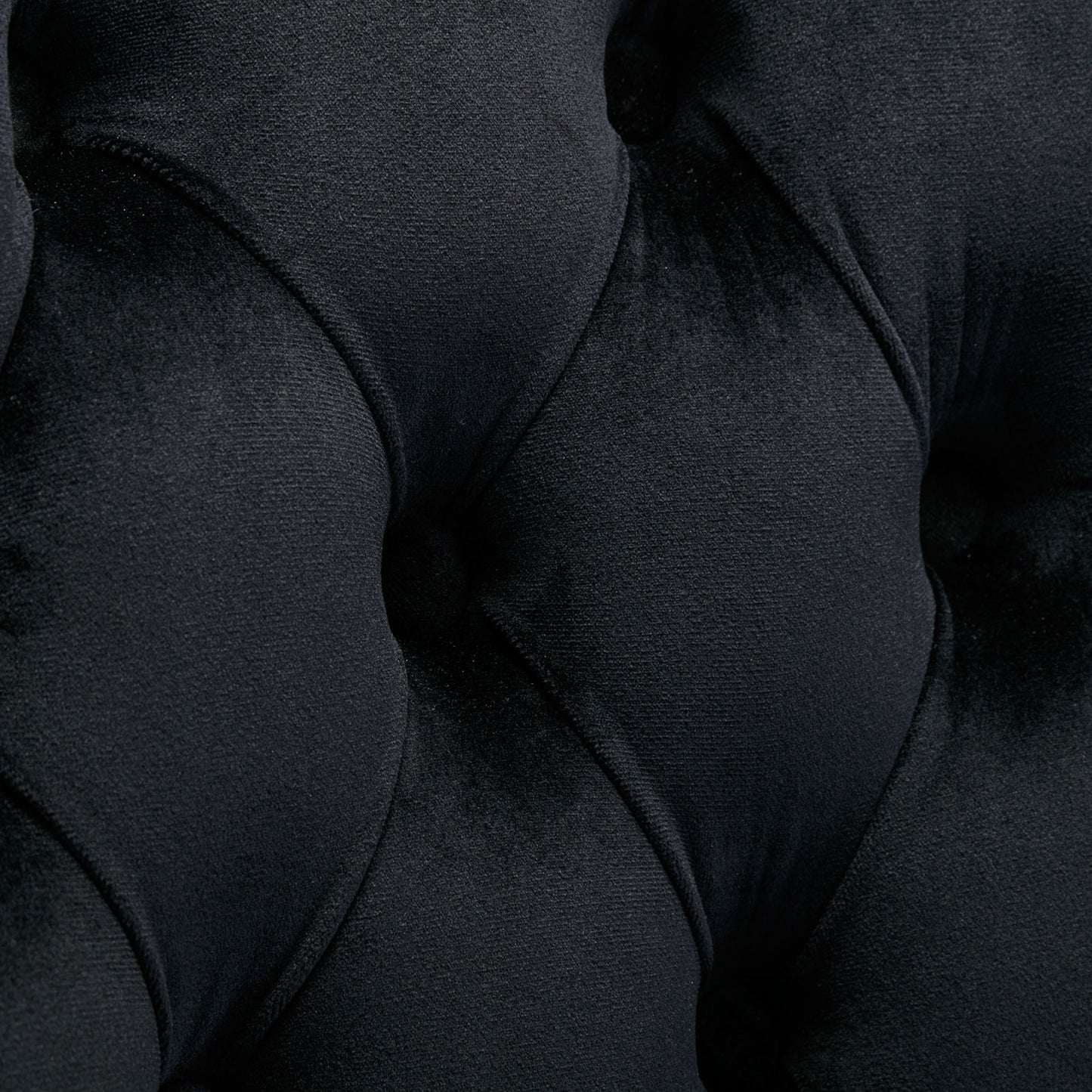 Closeup of black velvet tufted upholstery fabric