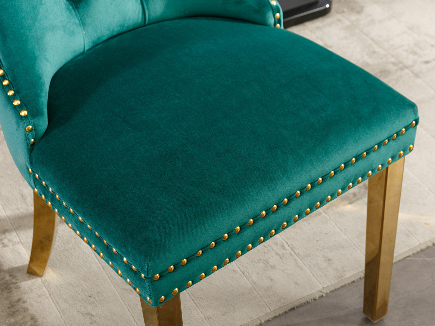 Emerald green velvet accent chair with gold nailhead trim and brass legs