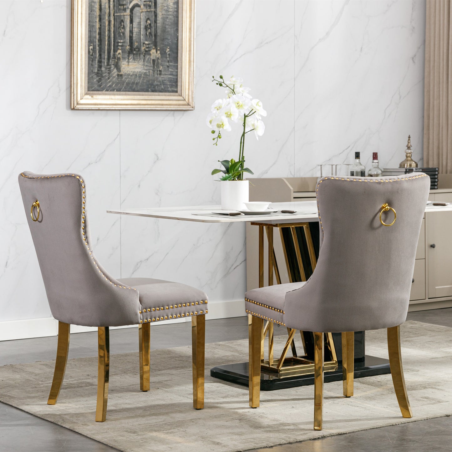 Grey velvet dining chair with gold ring pull and gold legs
