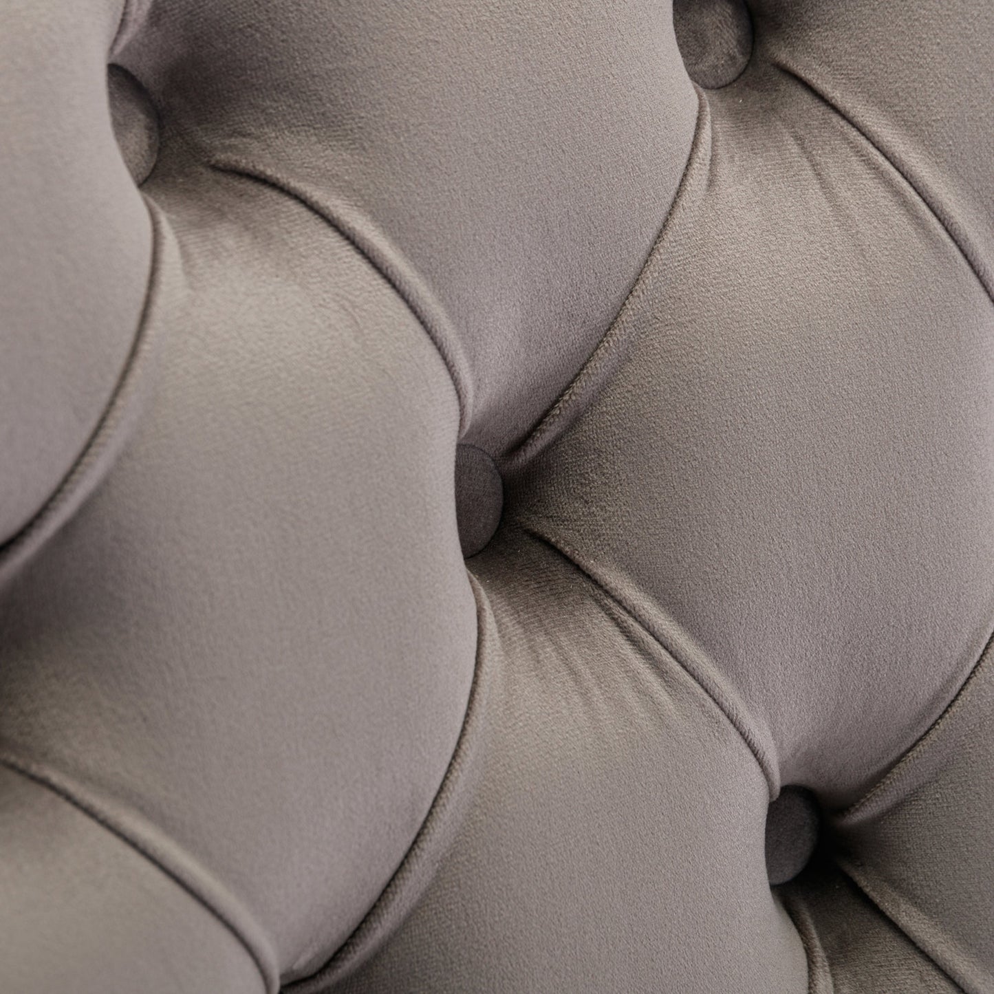 Closeup of grey velvet tufted upholstery